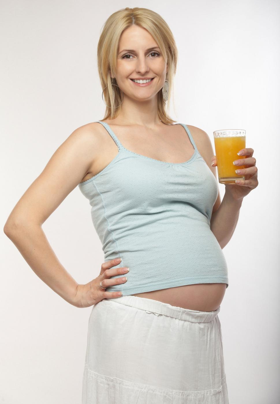 Free Image of Pregnant woman holding a glass of juice 
