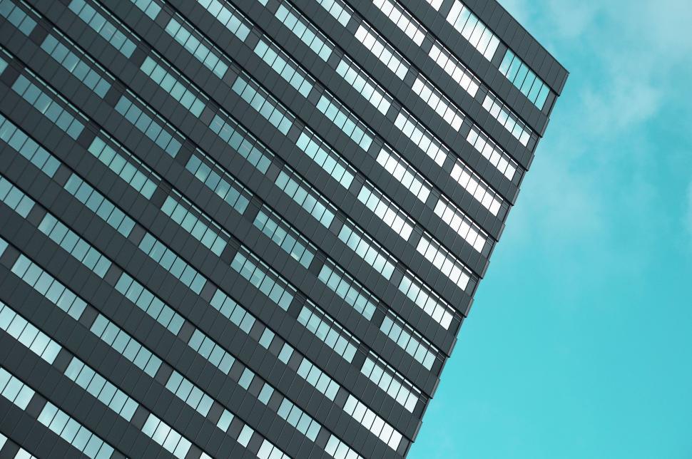 Perspective view of a modern skyscraper against sky