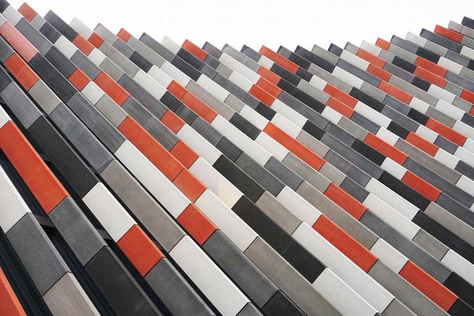 Free Image of Geometric building facade in shades of grey and red 