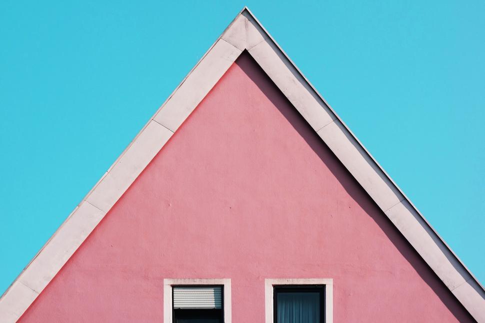 Free Image of Triangular roof of a pink house on blue sky 
