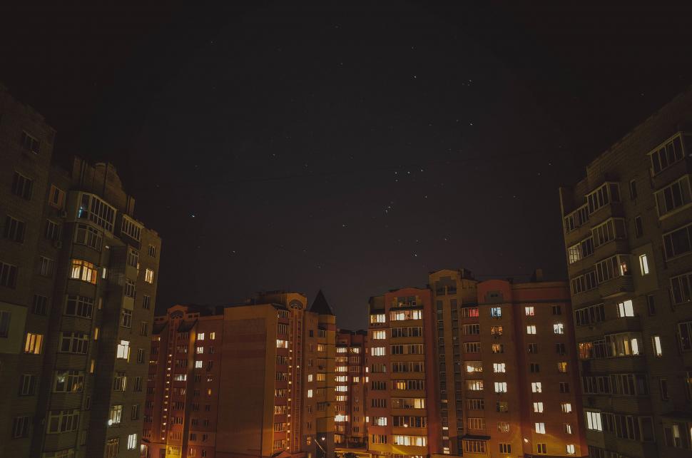 Free Image of Starry sky between apartment buildings at night 