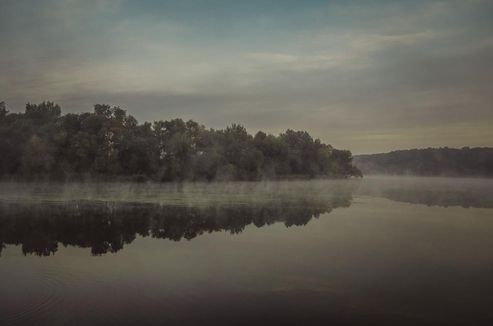 Free Image of Misty forest reflection on calm river 
