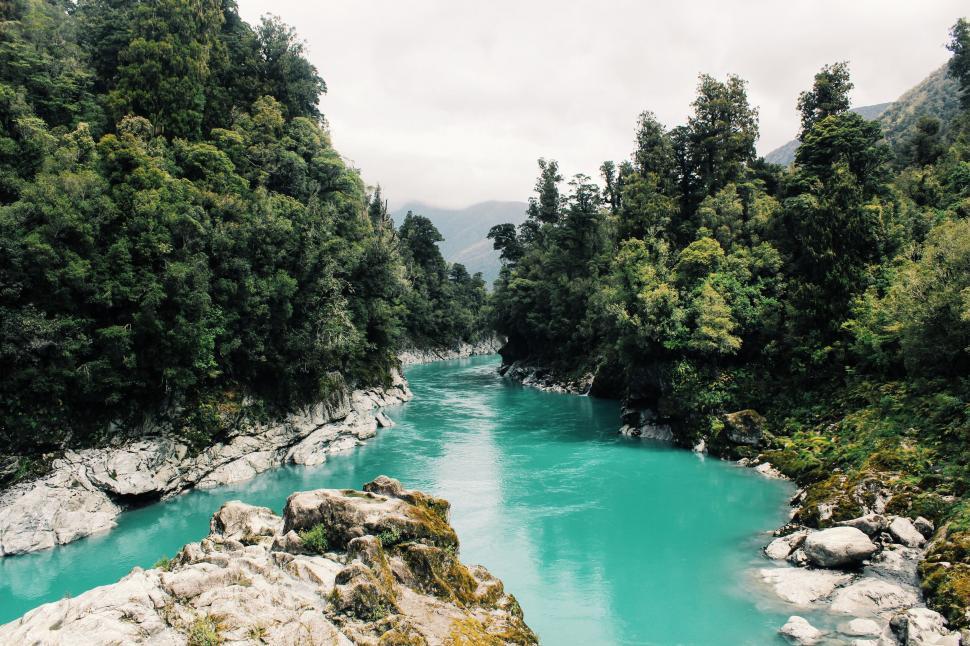Free Image of Turquoise river flowing through rocky valley 