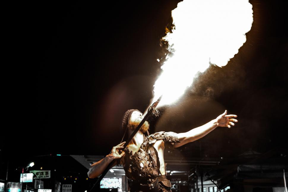 Free Image of Fire performer breathing flames at night 