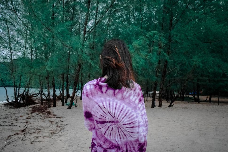Free Image of Woman in tie-dye shirt at a beach 