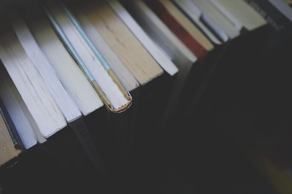 Free Image of Stack of books close-up in dim light 