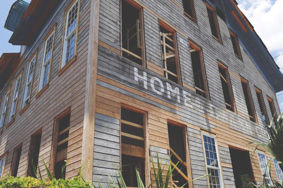 Free Image of Unfinished wooden house with HOME sign 