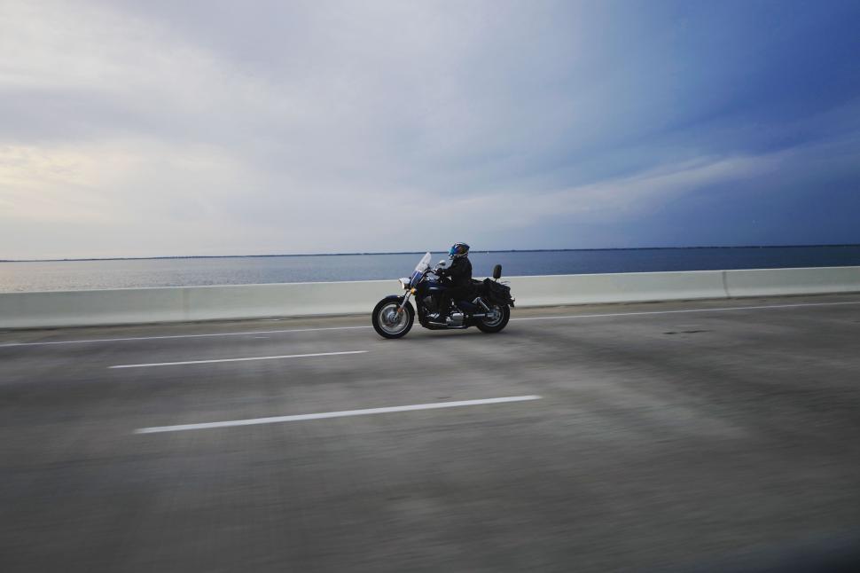 Free Image of Motorcyclist riding on an open road 