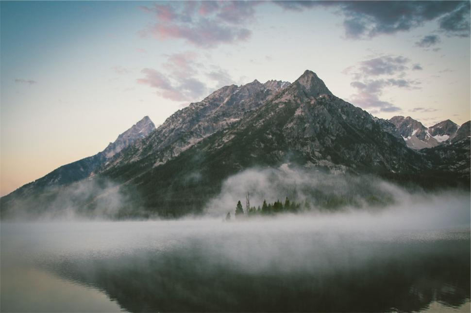 Free Image of Majestic mountain peak rising above misty lake 