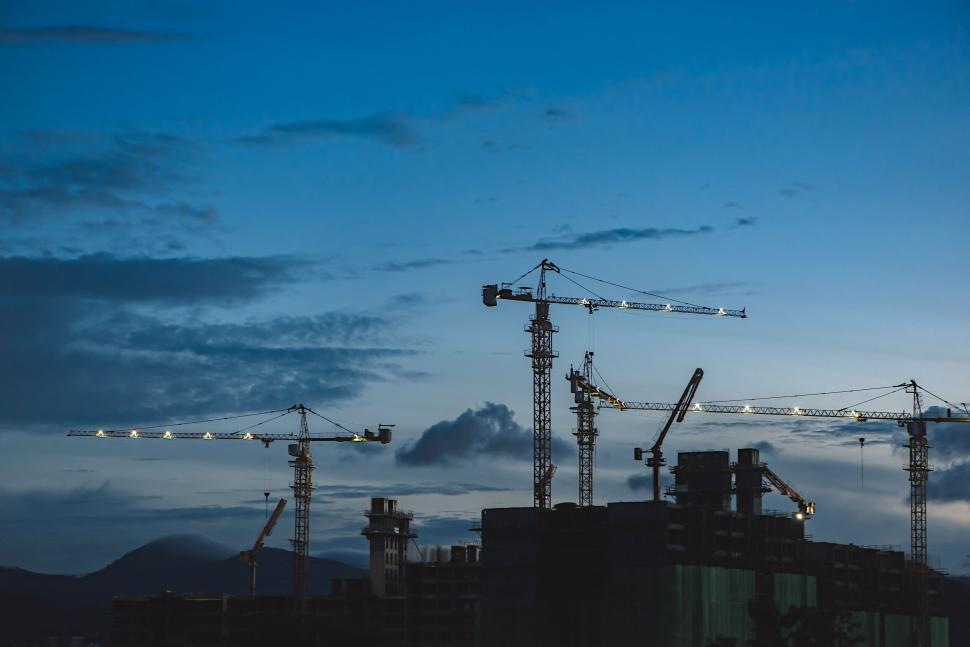 Free Image of Construction cranes against evening sky 