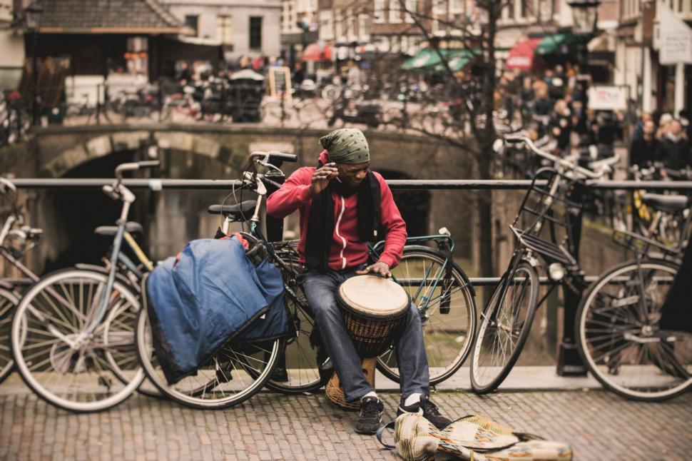 Free Image of Street musician playing drum on urban background 