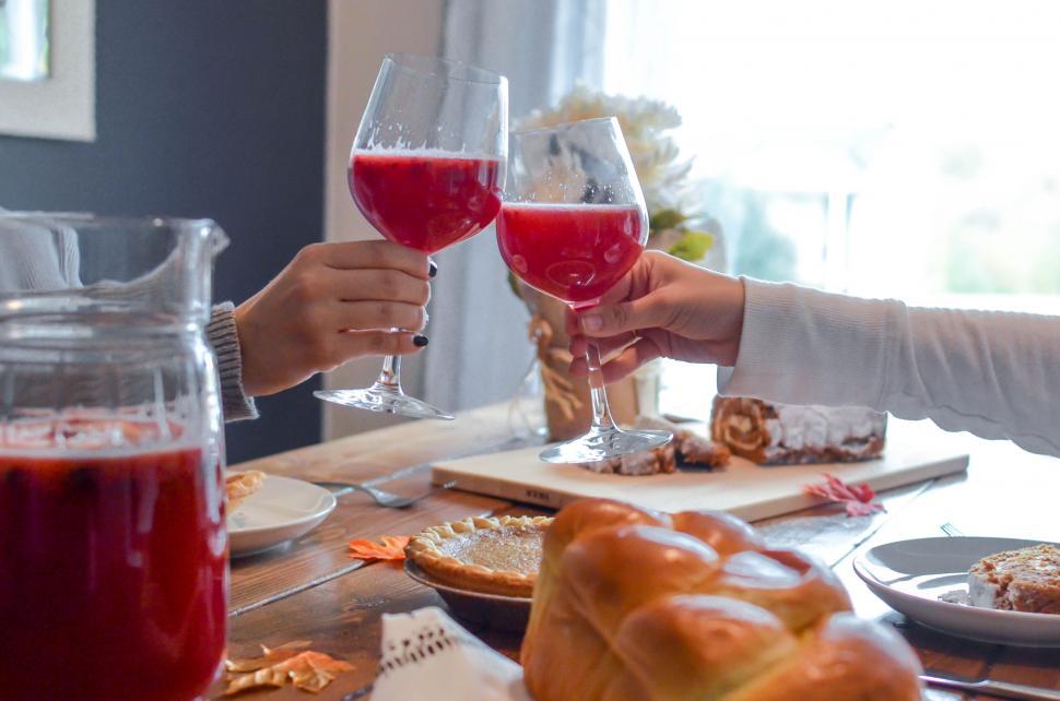 Free Image of Friends toasting with red wine at a home dinner 