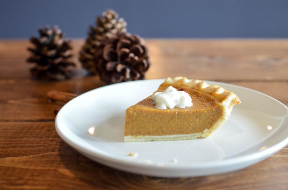 Free Image of Slice of pumpkin pie with whipped cream on top 