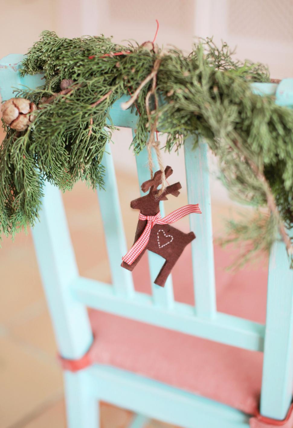 Free Image of Rustic reindeer decoration on a turquoise chair 