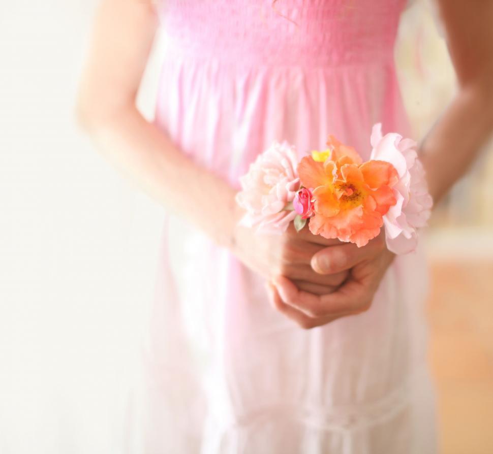 Free Image of Girl in pink dress holding colorful flowers 