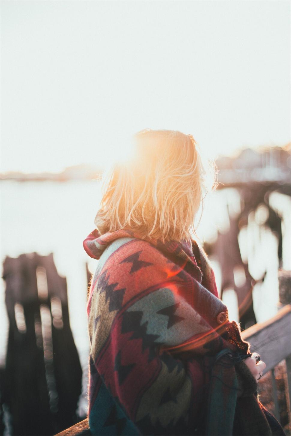 Free Image of Person wrapped in blanket at sunset 
