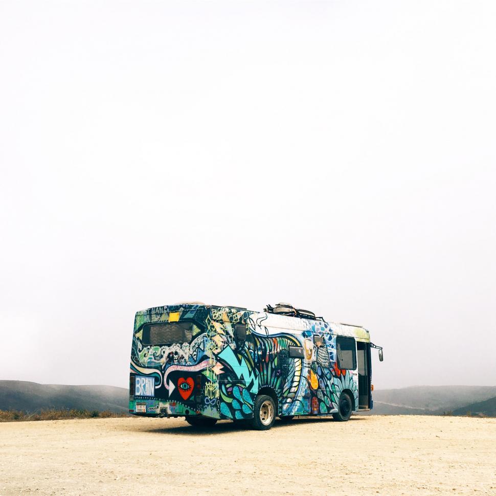 Free Image of Graffiti-covered bus in foggy desert landscape 