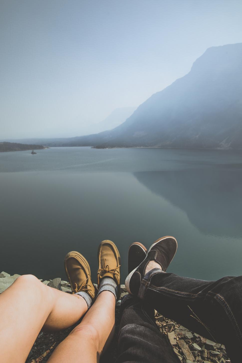 Free Image of Two friends enjoying a lakeside view 