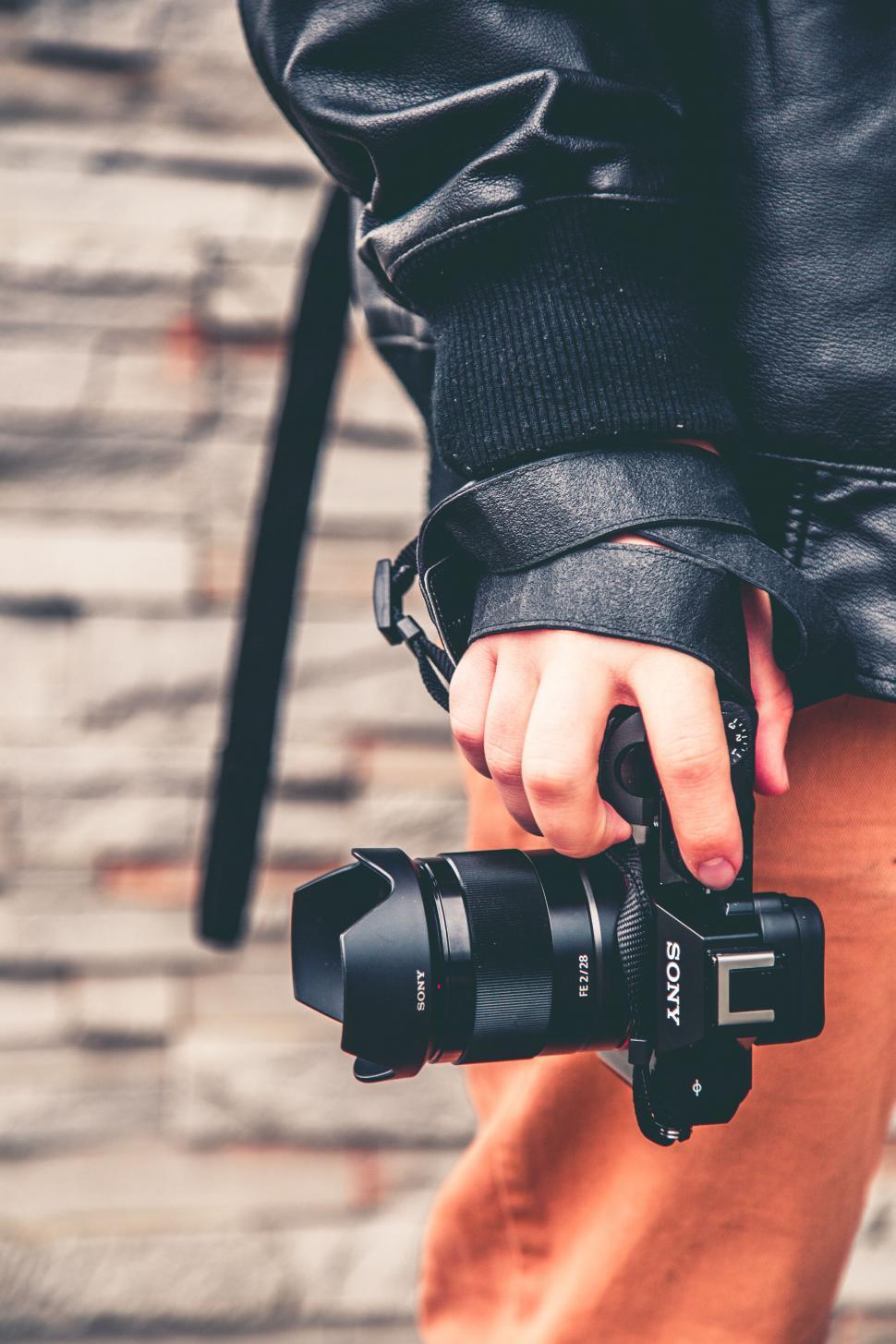 Free Image of Photographer holding a camera in hand 