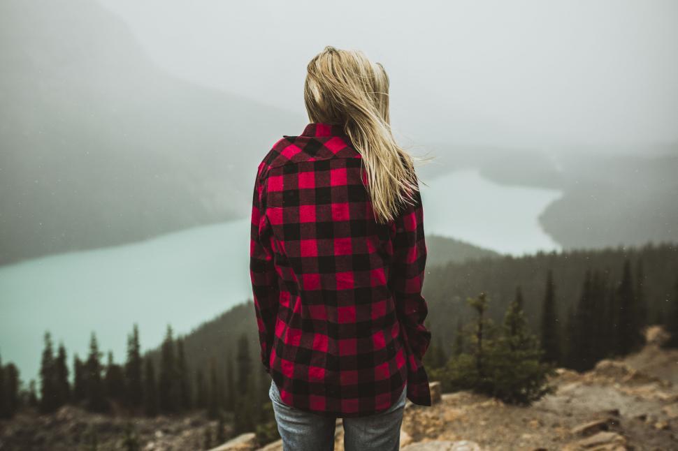 Free Image of Woman in plaid overlooking misty lake 