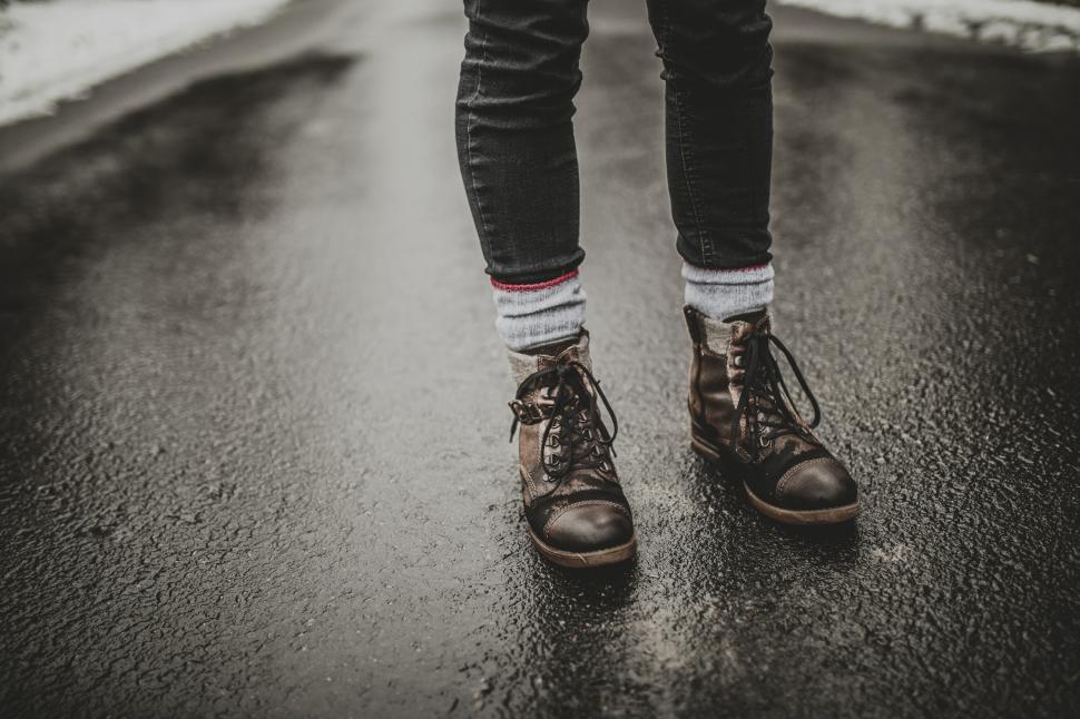 Free Image of Stylish brown boots on a wet road 