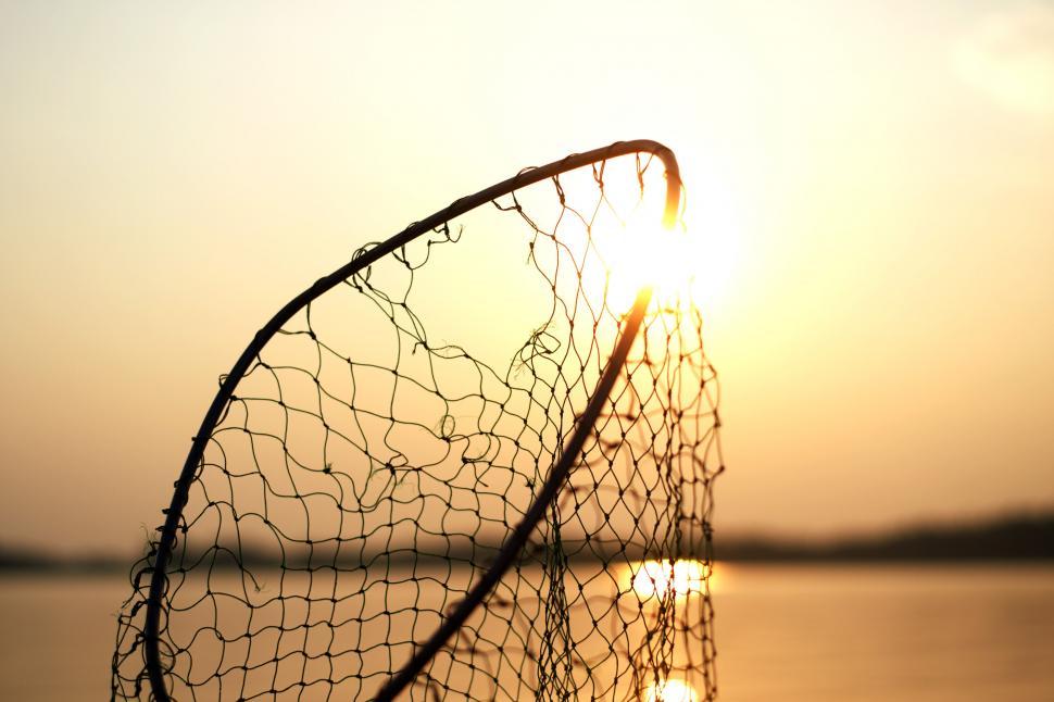 Free Image of Sunset through a fishing net silhouette 