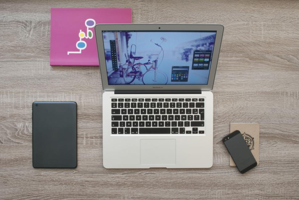 Free Image of Workspace with laptop mobile and stationery items 
