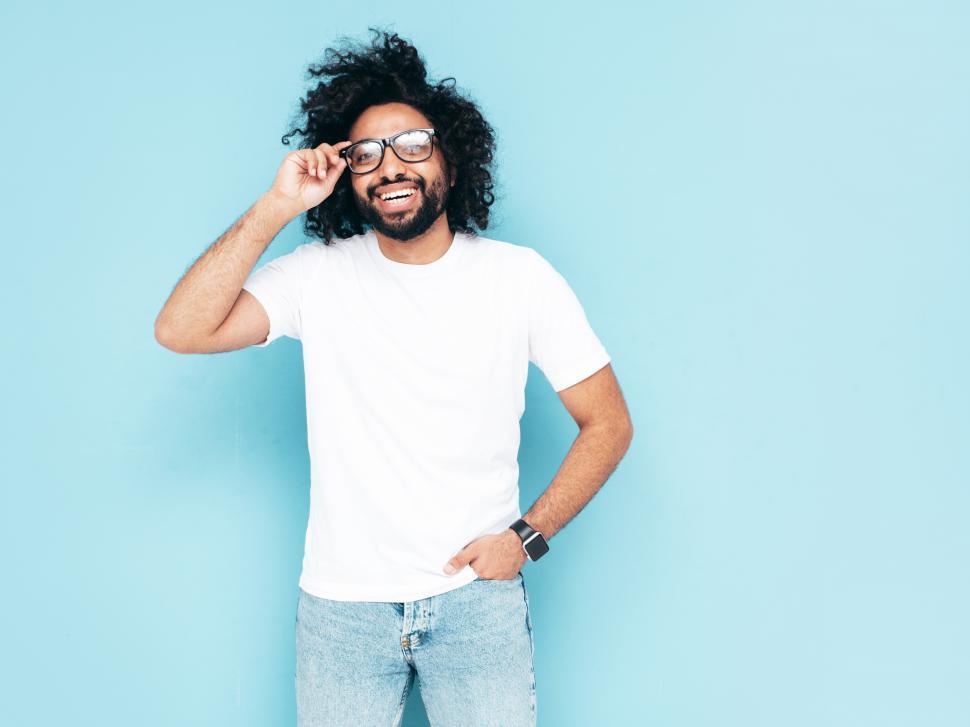 Free Image of A man with curly hair wearing glasses 