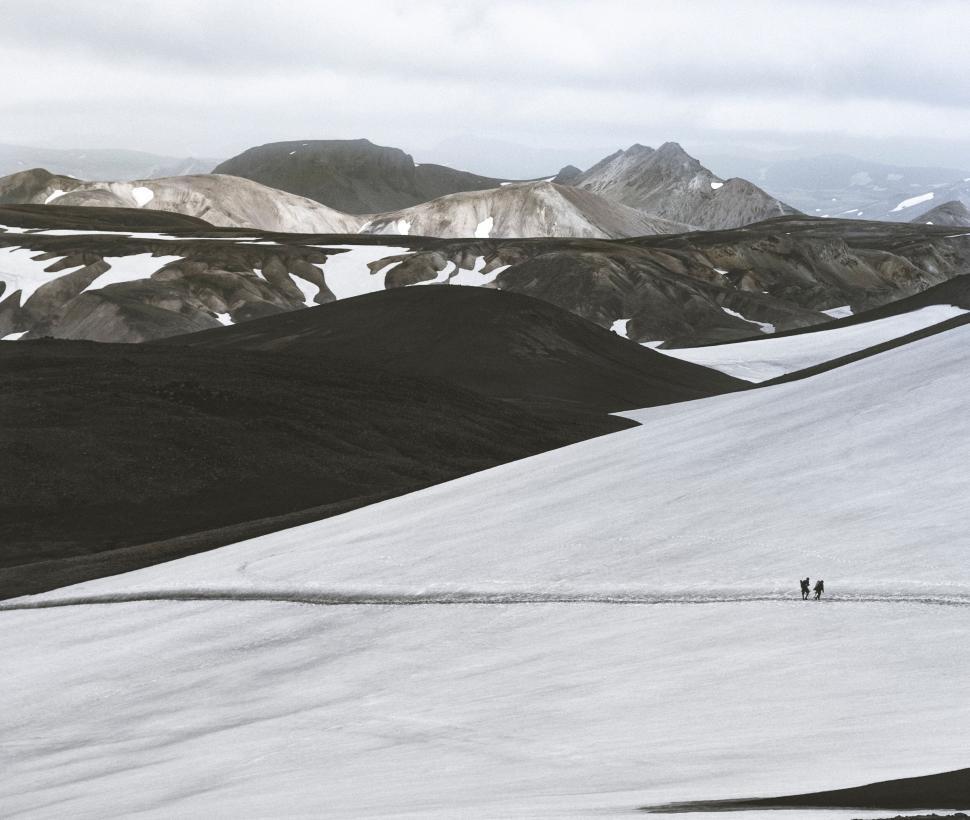 Free Image of Snowy trek paths in a mountainous winter landscape 