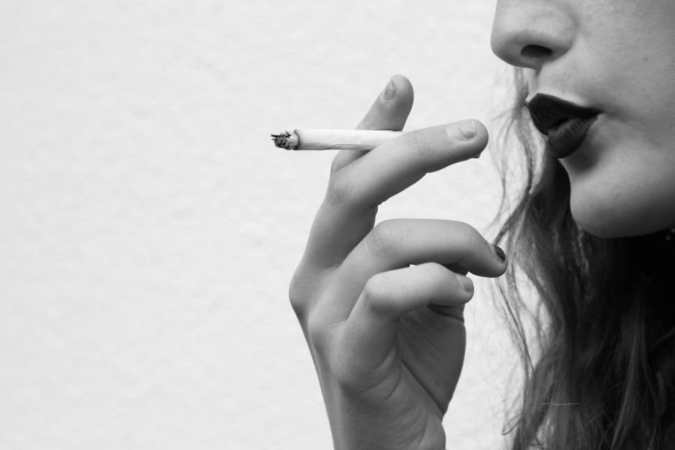 Free Image of Black and white close-up of smoking a cigarette 