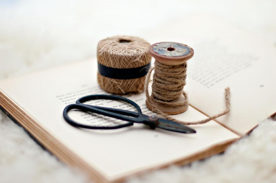 Free Image of Vintage sewing supplies on an open book 