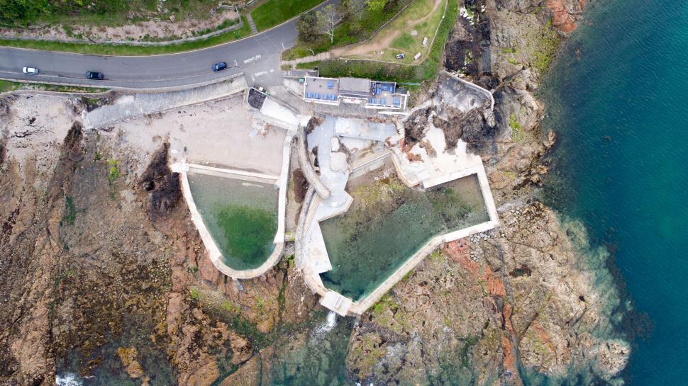 Free Image of Drone shot of coastal pool and surrounding area 