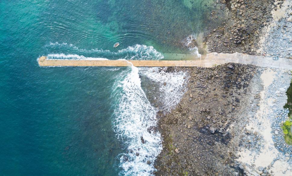 Free Image of Overhead view of pier stretching into the ocean 