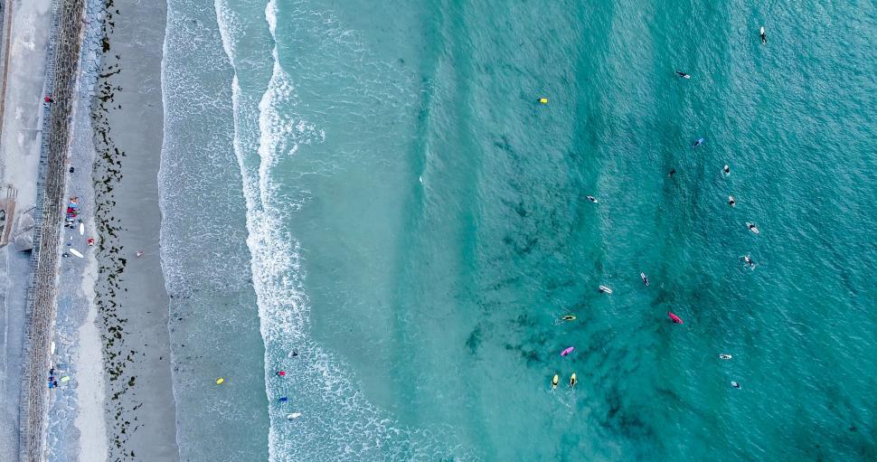 Free Image of Drone shot of beach with surfers and swimmers 