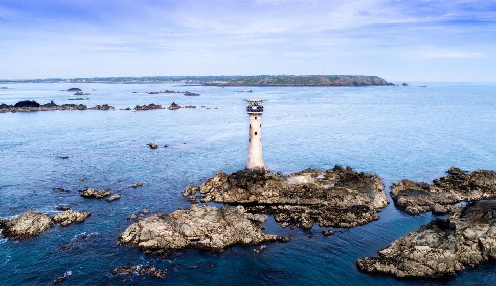 Free Image of Aerial photo of a lighthouse on rocky islets 