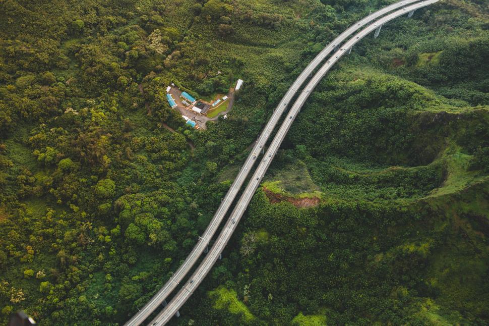 Free Image of Aerial view of a highway through lush greenery 