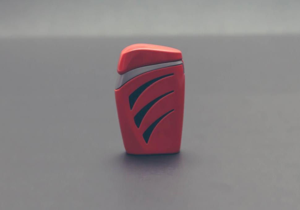 Free Image of Red floss device on a gray background 