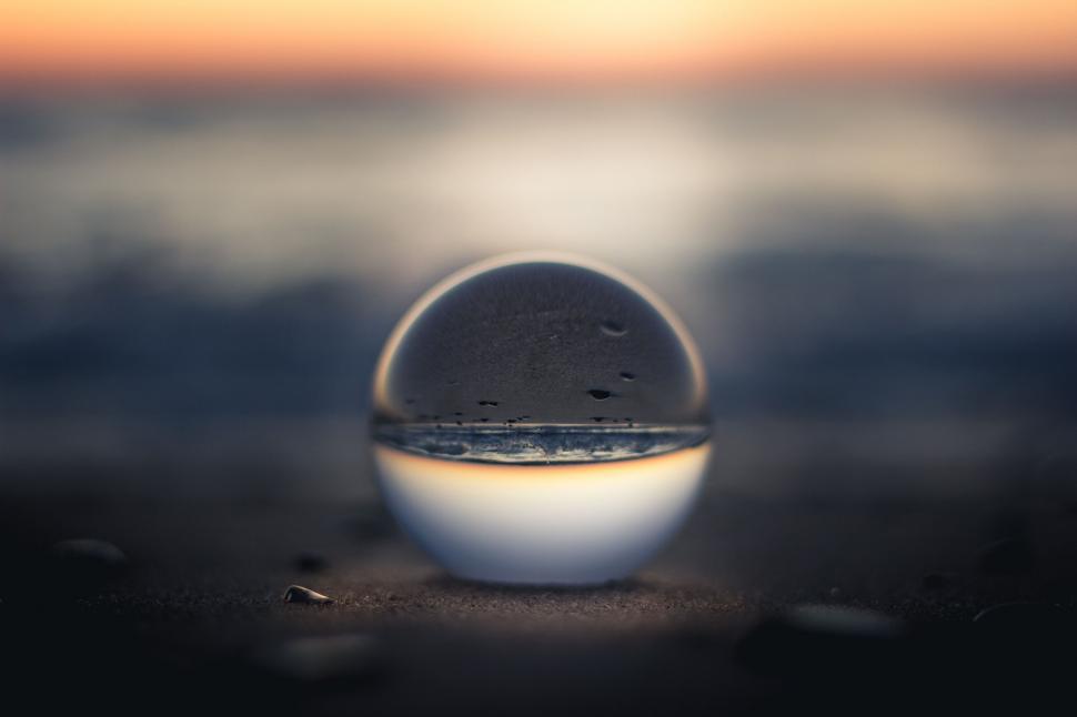 Free Image of Crystal ball reflecting beach sunset 