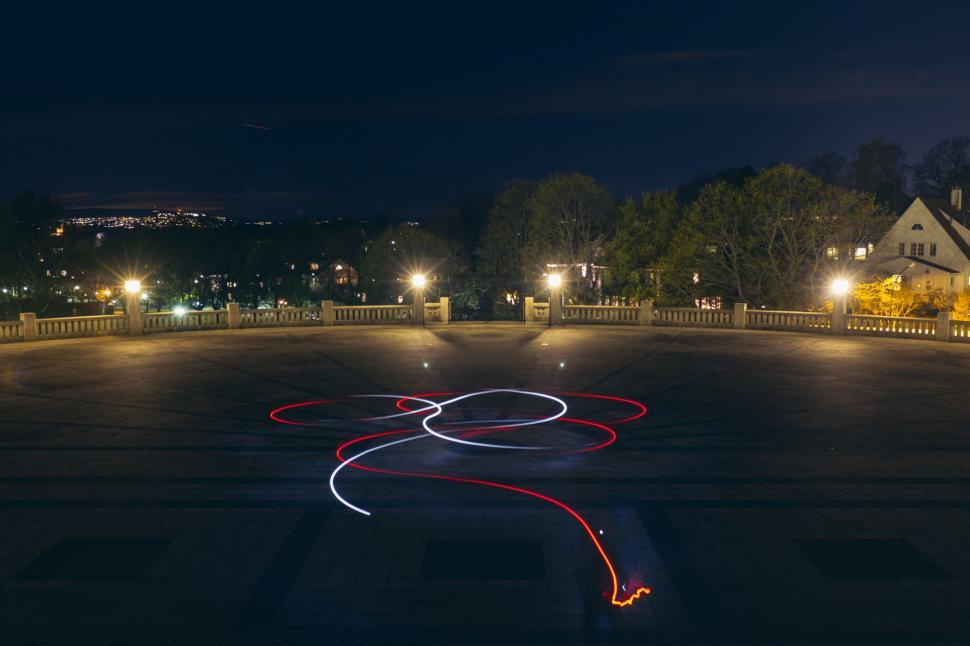 Free Image of Night view of empty square with light trails 