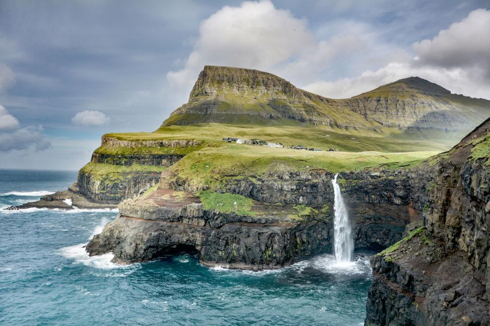 Free Image of Breathtaking waterfall on coastal cliffs of Faroe Islands 