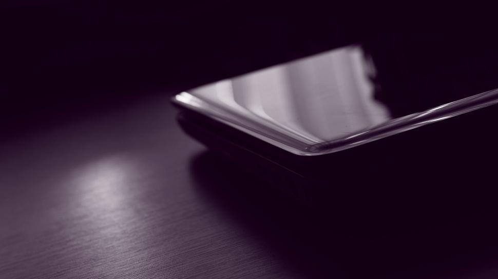 Free Image of Mobile phone resting at an angle on table 