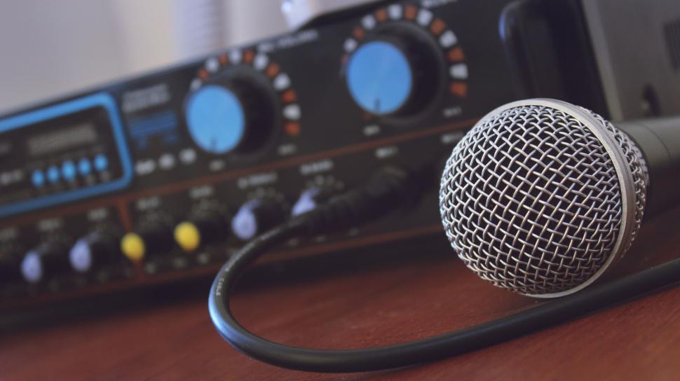 Free Image of Microphone and audio mixer on a desk 