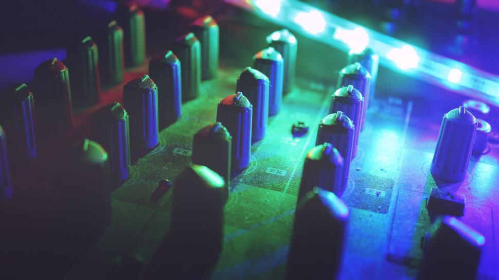 Free Image of Illuminated sound mixer in moody lighting 