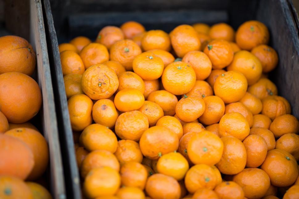 Free Image of Fresh oranges piled in wooden crate 