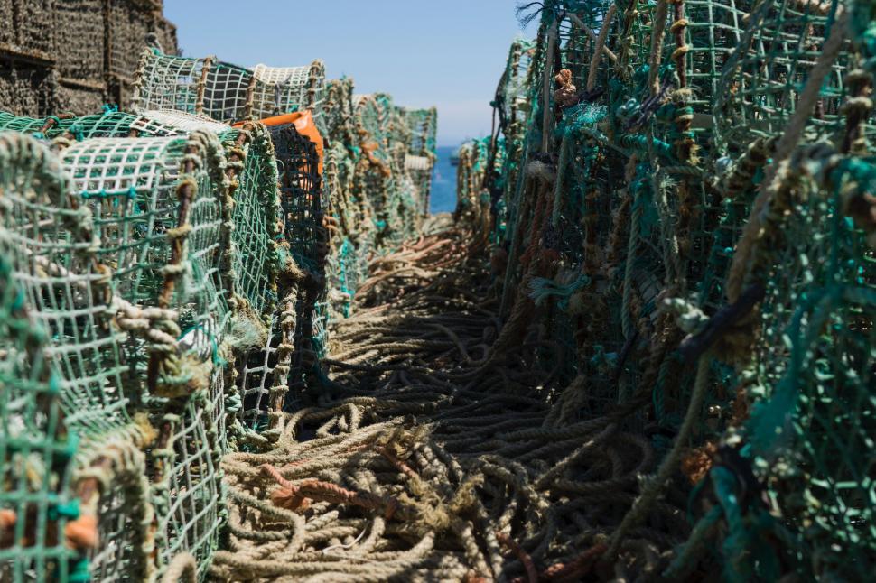 Free Image of Stacked colorful fishing traps on pier 
