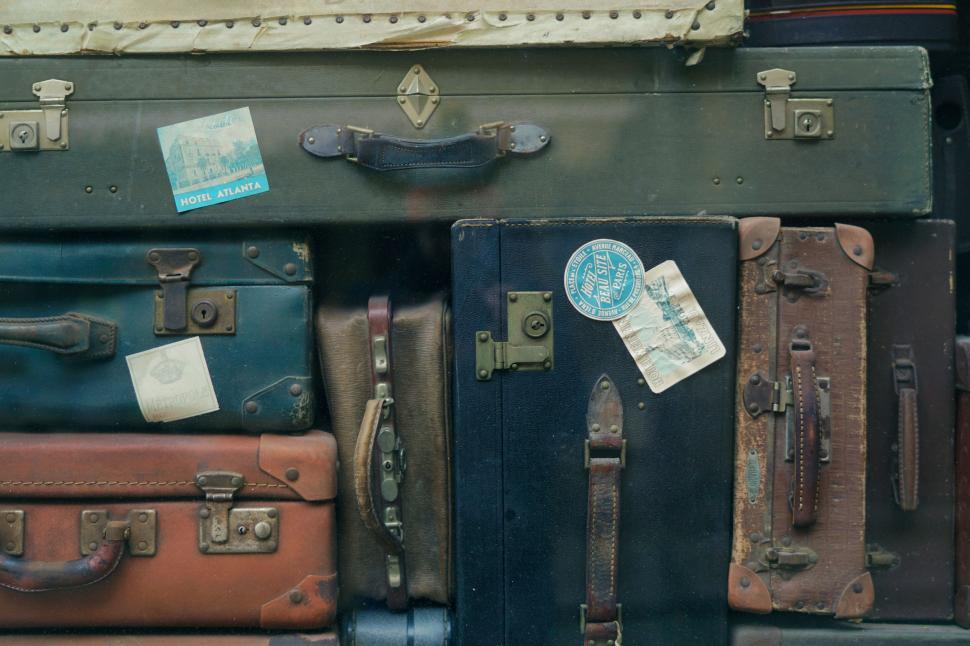 Free Image of Vintage suitcases with travel stickers 