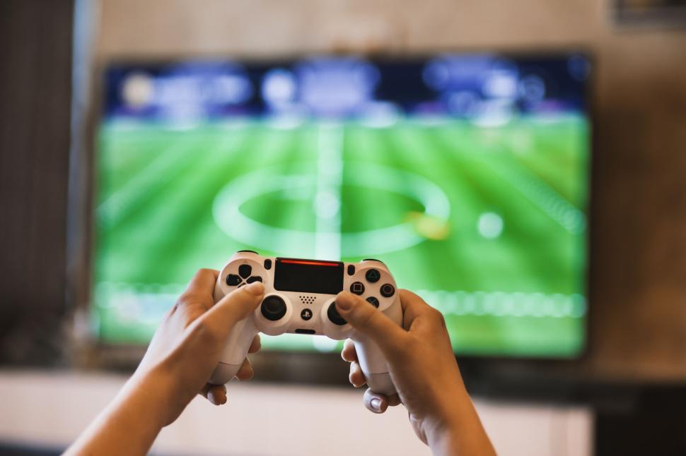 Free Image of Playing a soccer game on a console 