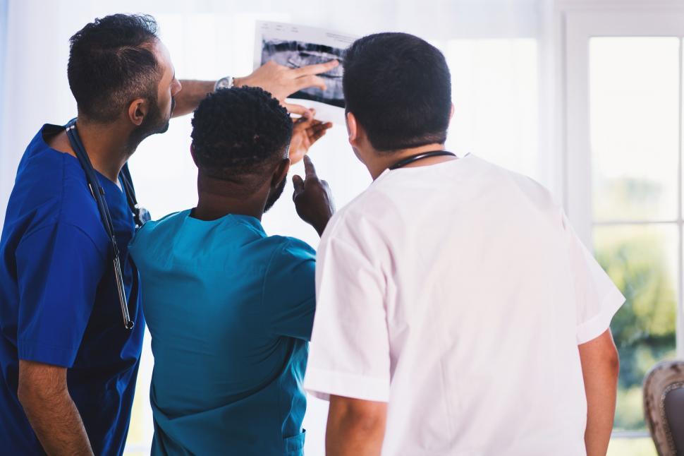 Free Image of Medical team analyzing a patient s X-ray 