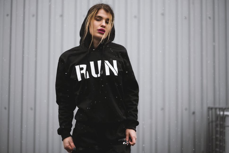 Free Image of Woman in a black hoodie with  RUN  text 