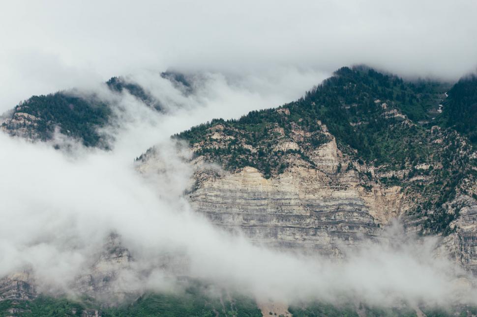 Free Image of Mountains obscured by mist and clouds 